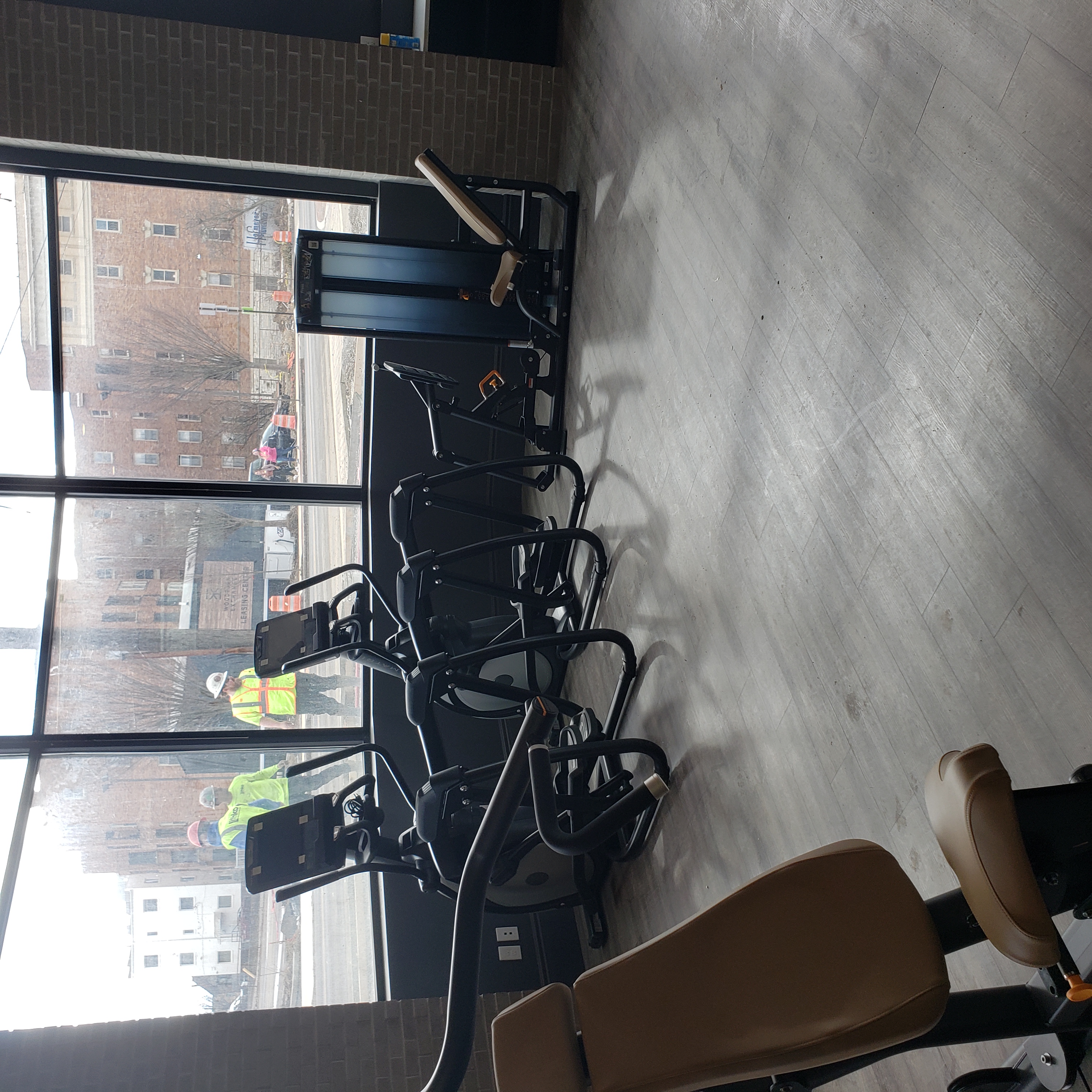 Two ellipticals in front of a window