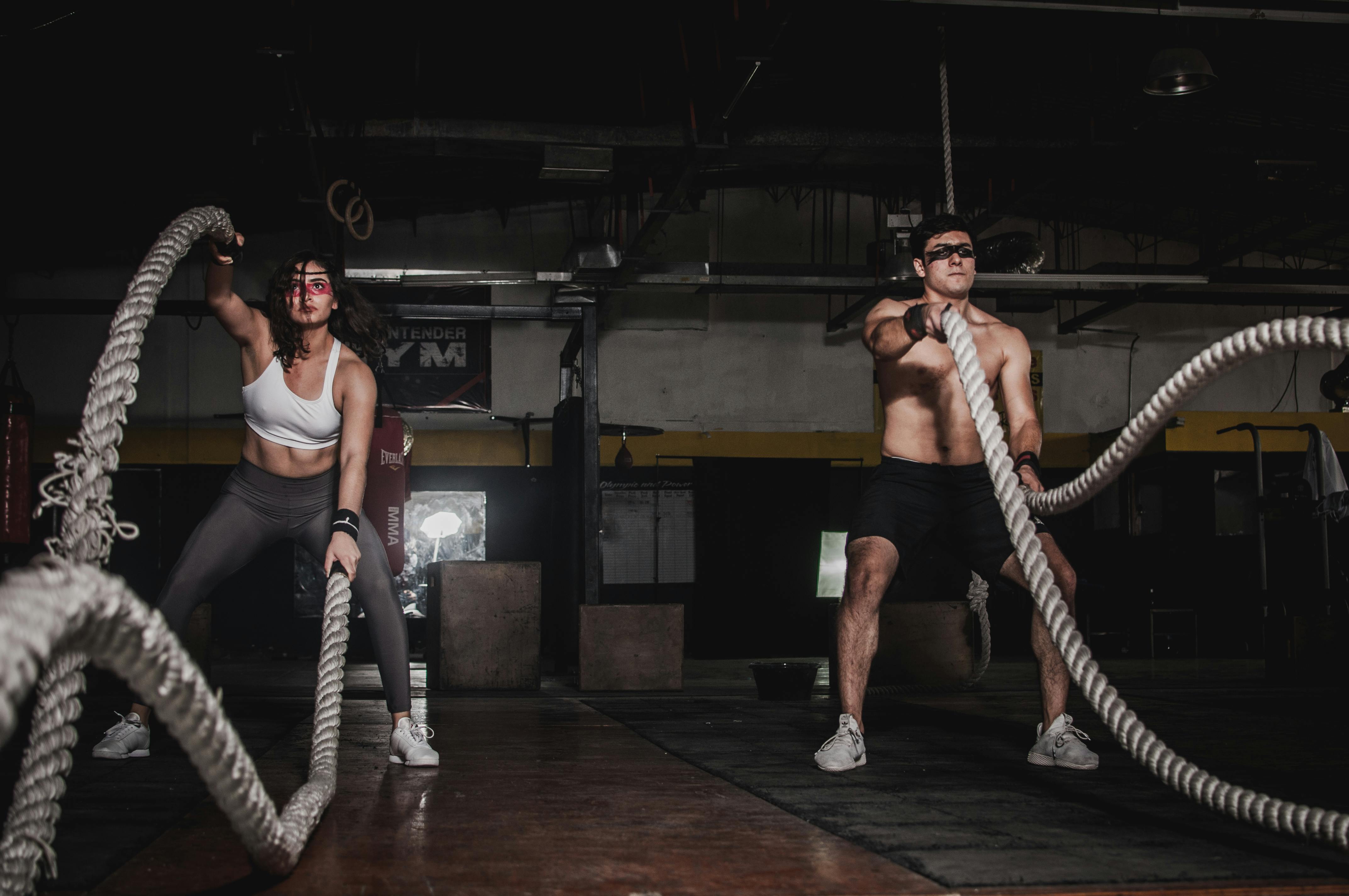 Two people working out with ropes